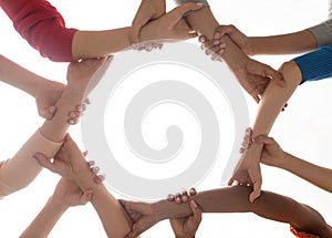 Close up of international women holding hands