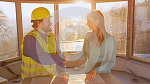 CLOSE UP: Investor and architect shake hands after discussing construction plans