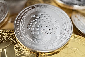 Close-up of iota physical coin on stack of many other cryptocurrencies photo