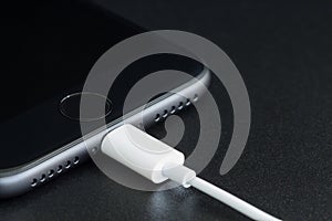 Close-up iPhone 7 matte black connect to usb cable