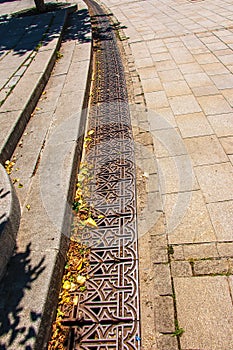 Close-up iron grate drainage system for draining rainwater in Slovakia