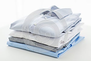 Close up of ironed and folded shirts on table photo