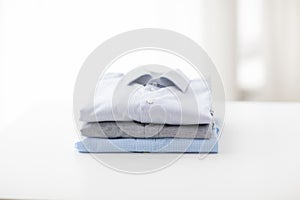 Close up of ironed and folded shirts on table