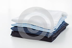 Close up of ironed and folded t-shirts on table