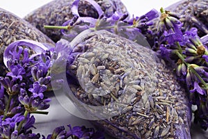 Close up of isolated bagged dried lavender blossom sacs used as moth repellent in wardrobe for clothes protection, white photo