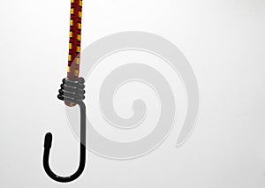 Close up of isolated black metal hook with elastic rope, white background focus on center