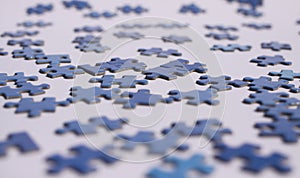 Close up of isolated blue puzzle pieces, white background