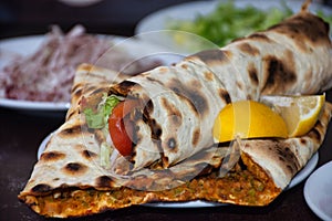 Isolated lahmacun, turkish pizza with vegetable served on plate