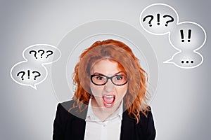 Close up isolated portrait of young annoyed angry woman. Negative human emotions face expressions. Isolated portrait on a gray bac