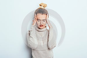 Close up isolated portrait of young stressed angry woman holding hands on head. Negative human emotions, headache face expressions