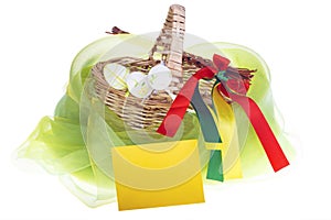 Close-up of isolated strawy basket on white background with Easter eggs