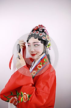 Close-up isolated white background Beijing opera Chinese female actress woman makeup comb traditional headwear costume drama show