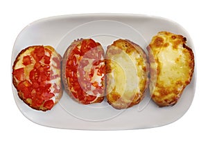 Close up of italian bruschetta bread with cheese, tomato and garlic, serving on white plate. isolated on white background