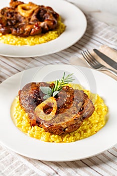 Close up of Italian dish Ossobuco meat, specialty of Lombard cuisine of cross-cut beef shanks braised with onion, white wine, and