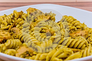 Close up of Italian pasta dish with yellow sauce and mushrooms