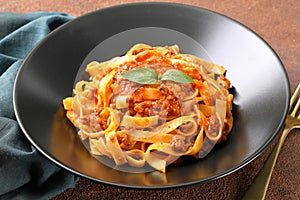 Italian pasta tagliatelle with meat and tomato sauce photo