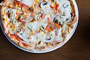 Close up Italian pizza with olives, tomatoes and che