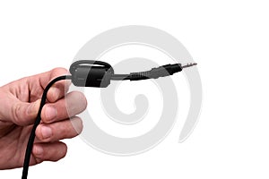 Close-up Jack plug and a cable. in the hands of a man on the white background.