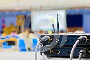 Close up Jack plug cables connected with old box of wireless microphone in conference meeting room