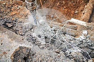 Close up of jackhammer - worker man using a jackhammer to drill into concrete