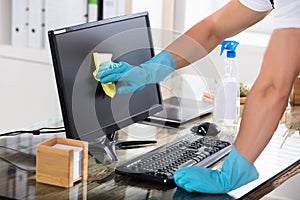 Close-up Of A Janitor Cleaning Computer Screen