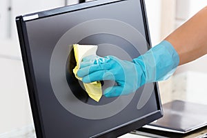 Close-up Of A Janitor Cleaning Computer Screen