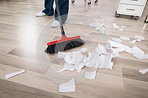 Close-up Of Janitor Sweeping Hardwood Floor