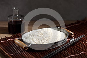 Close up Japanese rice in measuring cup on table