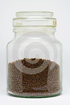 Close up of a jar containing instant coffee isolated on a white background