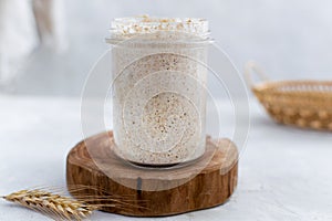 Close-up of jar with natural homemade sourdough levain starter for homemade bakery