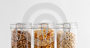 close up of jars with oat, corn flakes and granola