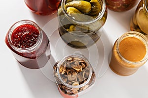 close up of jars and tin cans with preserved food