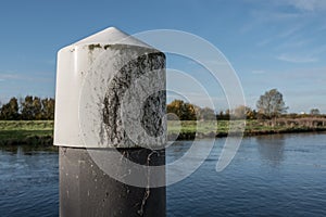 Close-up of a jetty float and water level structure seen in a river, which is part of a lock system.