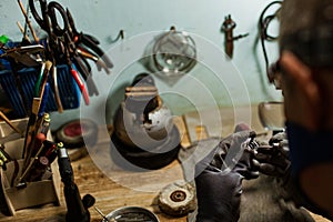 Close-up. The jeweler makes a silver ring