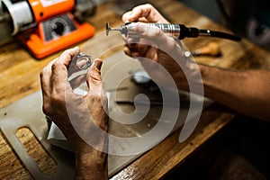 Close-up. The jeweler makes a silver ring