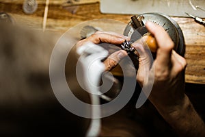 Close-up. The jeweler makes a silver ring