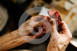 Close-up. The jeweler makes a silver ring