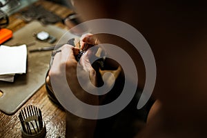 Close-up. The jeweler makes a silver ring