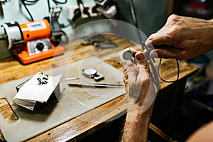 Close-up. The jeweler makes a silver ring