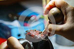 Close up of a jeweler`s hands doing a repair