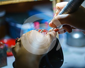 Close up of a jeweler`s hands doing a repair