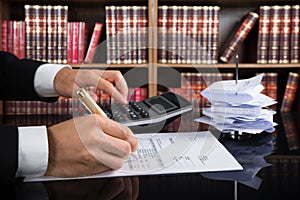 Judge Calculating Invoice In A Courtroom