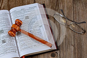 Close up of judge gavel on Bible world book on wooden table Christian God justice