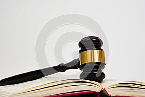 Close up of judge gavel, lawyer, law, justice placed on law book and white background. Law or jurisprudence concept.