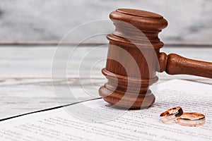 Close-up judge gavel and wedding rings.