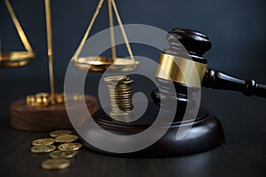 Close-up Of A Judge`s Hand Holding Gavel Over Stacked Golden Coins