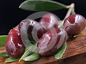 Close up of kalamon olives on wooden board