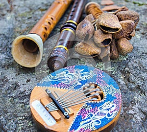 Close up of kalimba, rattle, flute and horn pipe music instruments