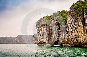 Close up of a karst rock raising from the sea water in Ha Long Bay, Vietnam