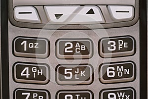 Close-up of the keyboard of a modern payment terminal. Rubber buttons with numbers and letters.